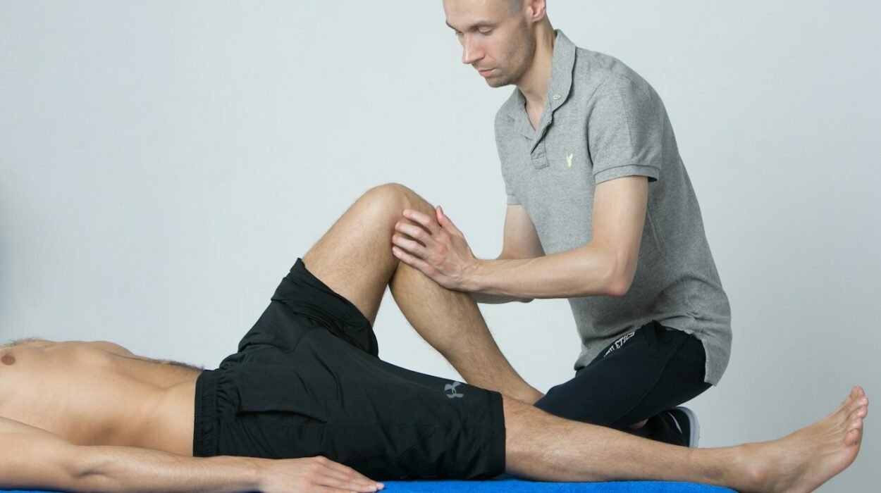 A physiotherapist assessing a man's knee on a treatment table