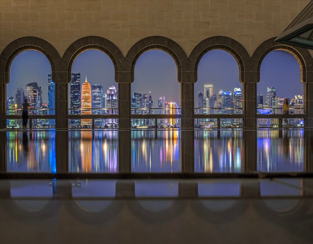Arched windows at the Museum of Islamic Art framing the West Bay skyline