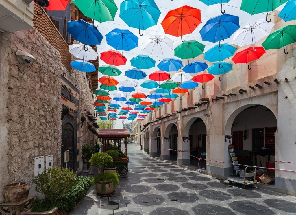 Colourful umbrellas shading a lane in Souq Waqif