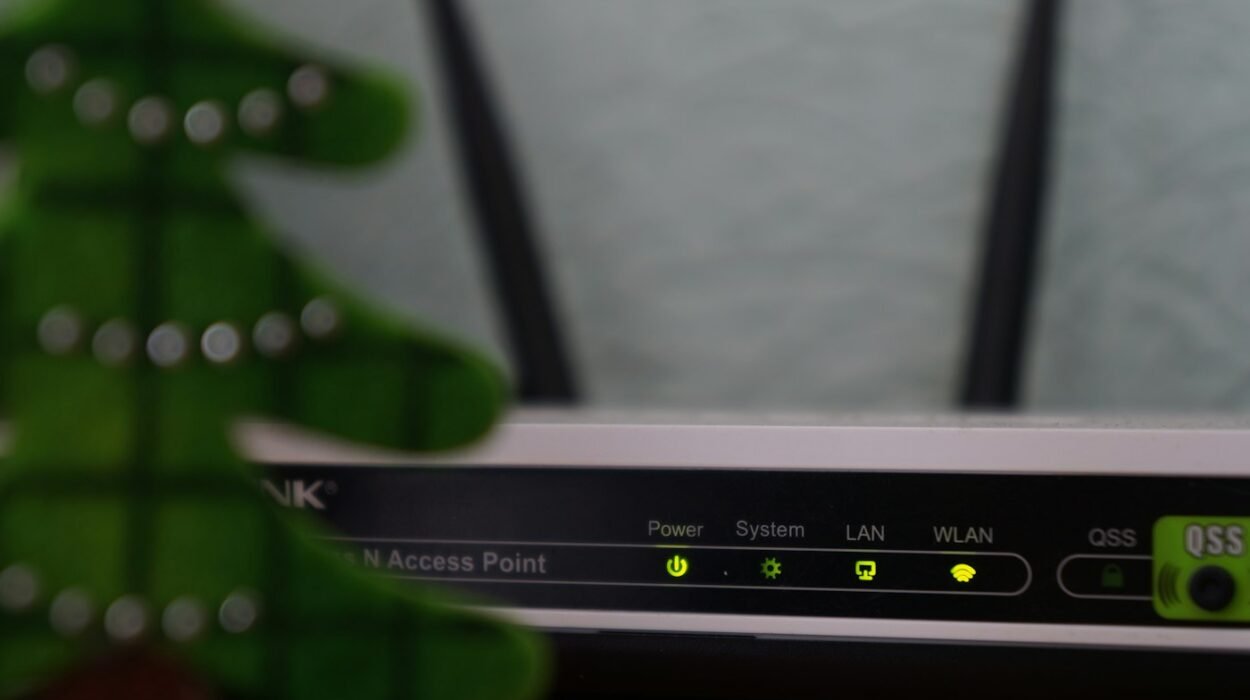 A wireless router with two antennas and lit status lights on a table